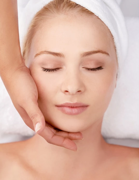 Face, Massage and Woman at a Spa with Hands of Masseuse for Lymphatic Drainage Procedure from above. Zen, Peace and Female with Facial Therapy at Beauty Salon for Skincare, Wellness or Stress