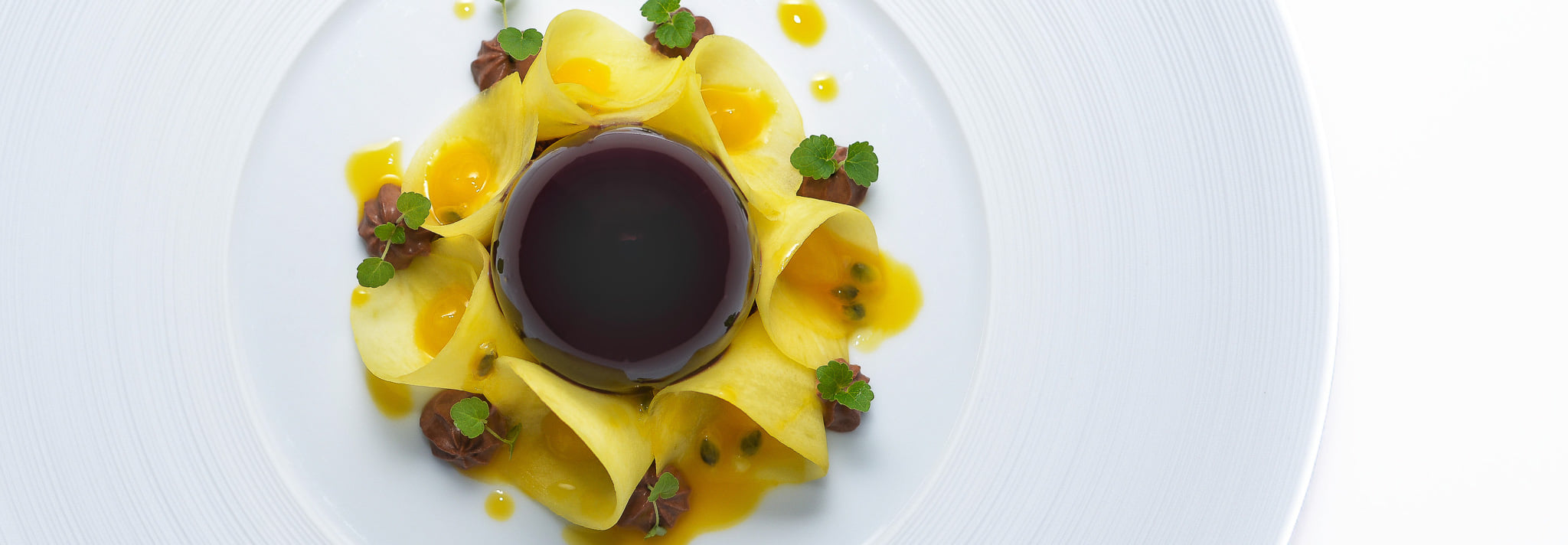 A gourmet and exotic-style dessert at gastronomic restaurant Le Cèdre de Montcaud, in the shape of a sunflower
